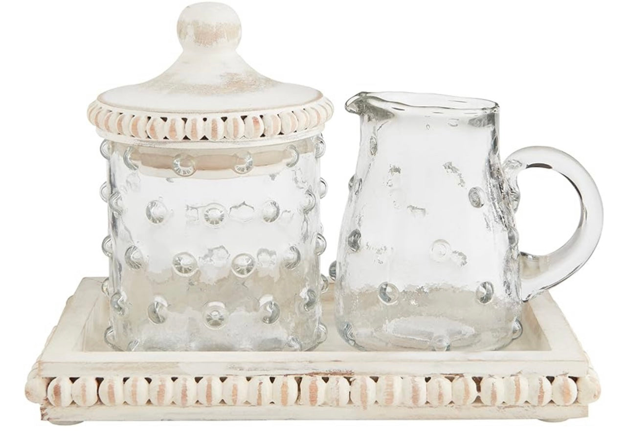 Clear glass cream and sugar set with a hobnail design.