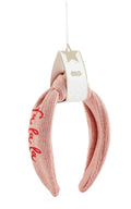 Pink Christmas Embroidered Topknot Headband with red lettering.