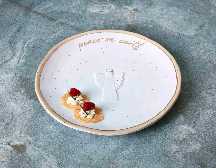 White platter with gold trim featuring an angel and "Peace on Earth".