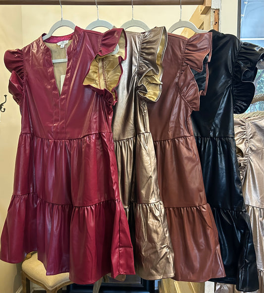 Assorted short sleeve pleather dresses.