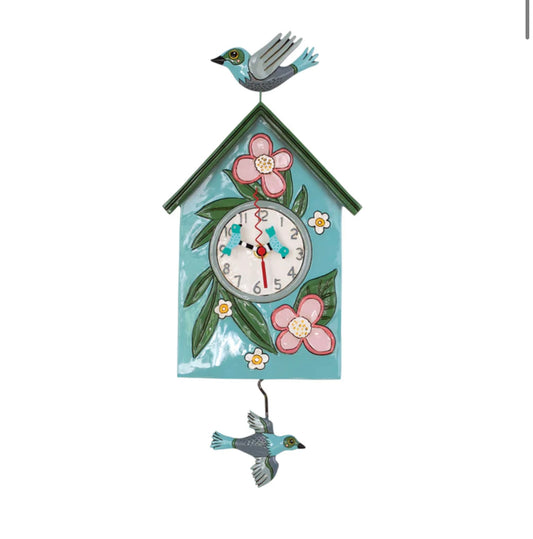 Blue birdhouse clock that has flowers on it, with birds in flight.
