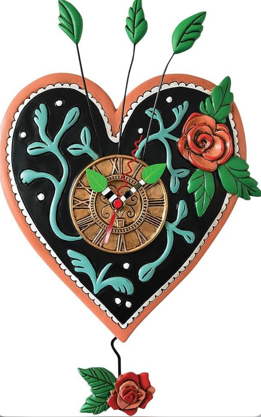 Clock in the shape of a heart with roses.