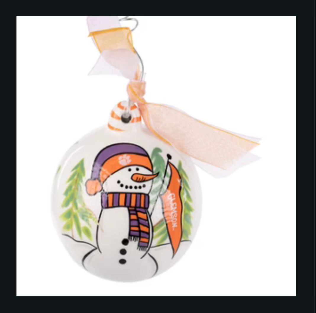 Christmas ornament featuring a snowman with a Clemson flag, hat, and scarf.