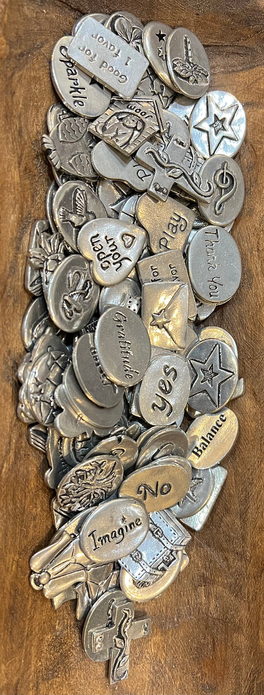 Assorted metal pocket charms with encouraging messages.
