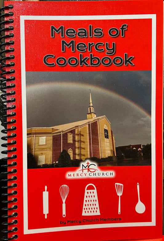 Red cookbook featuring Mercy Church titled "Meals of Mercy Cookbook".