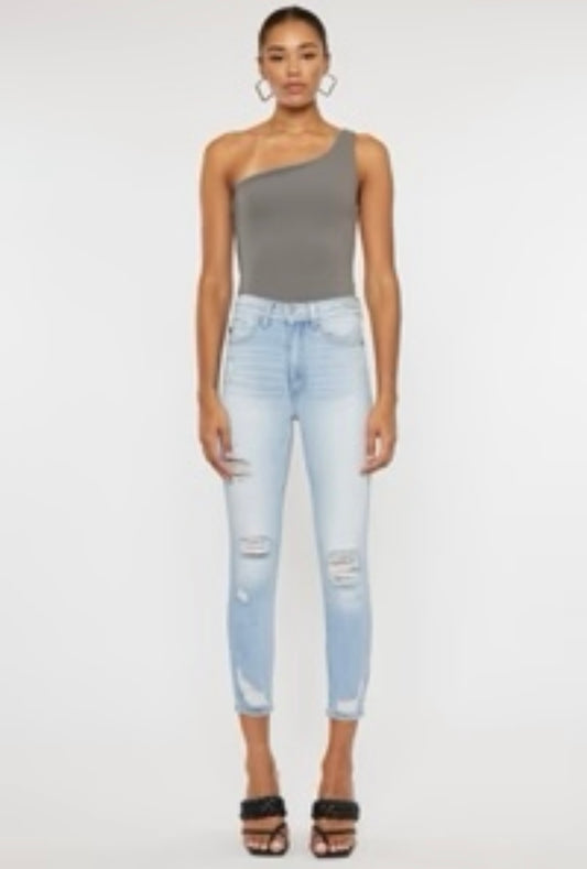 Model featuring light wash skinny jeans.