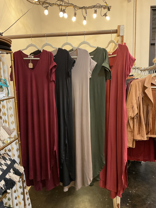 Assorted jersey knit V-neck maxi dress featuring pocket detail at side.