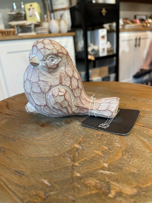 Carved, wooden, white-washed bird.