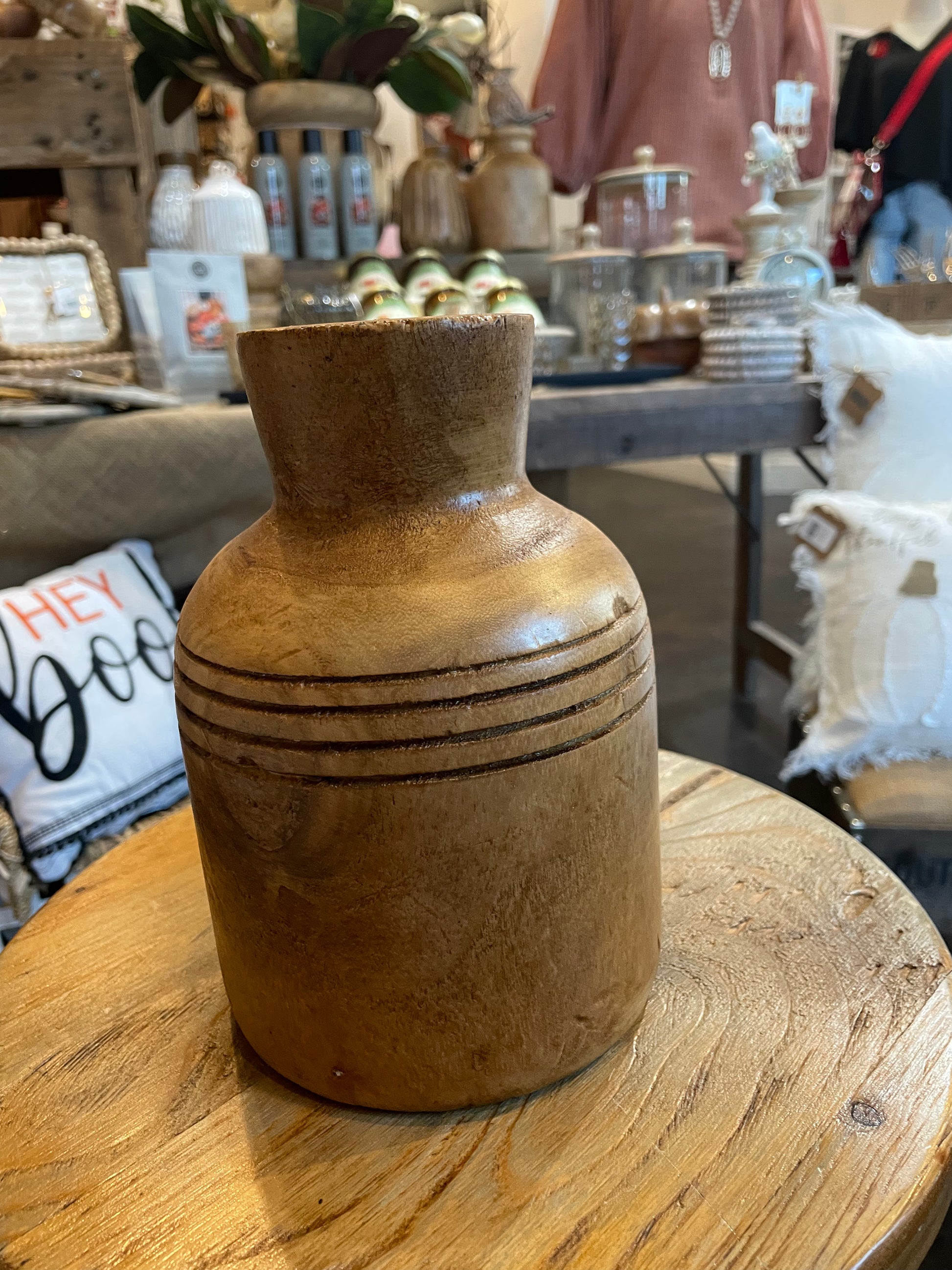 7-inch wooden vase with a medium stain.