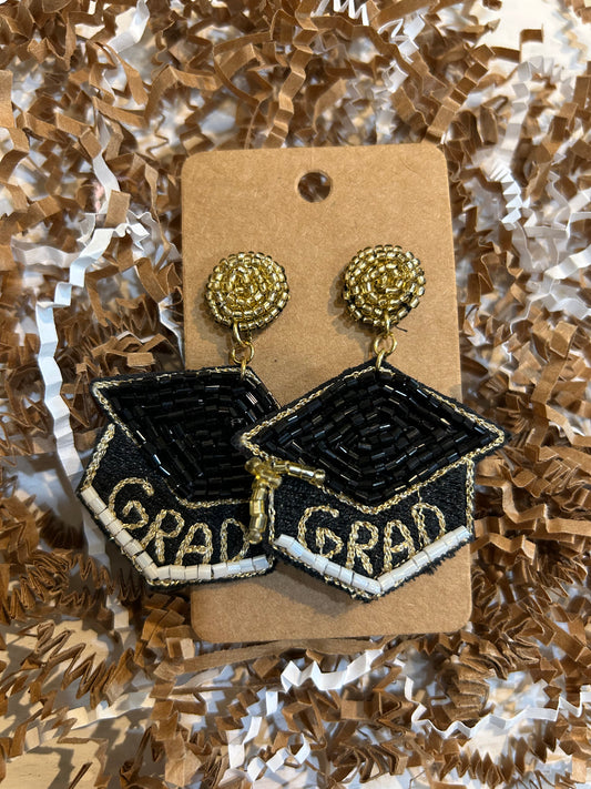 Beaded dangling earrings featuring a graduation cap with "GRAD" with golden studs.