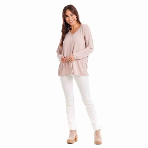 Model featuring blush soft V-neck long sleeve top.