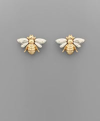Small stud earrings in the shape of a bee. Gold with silver wings.