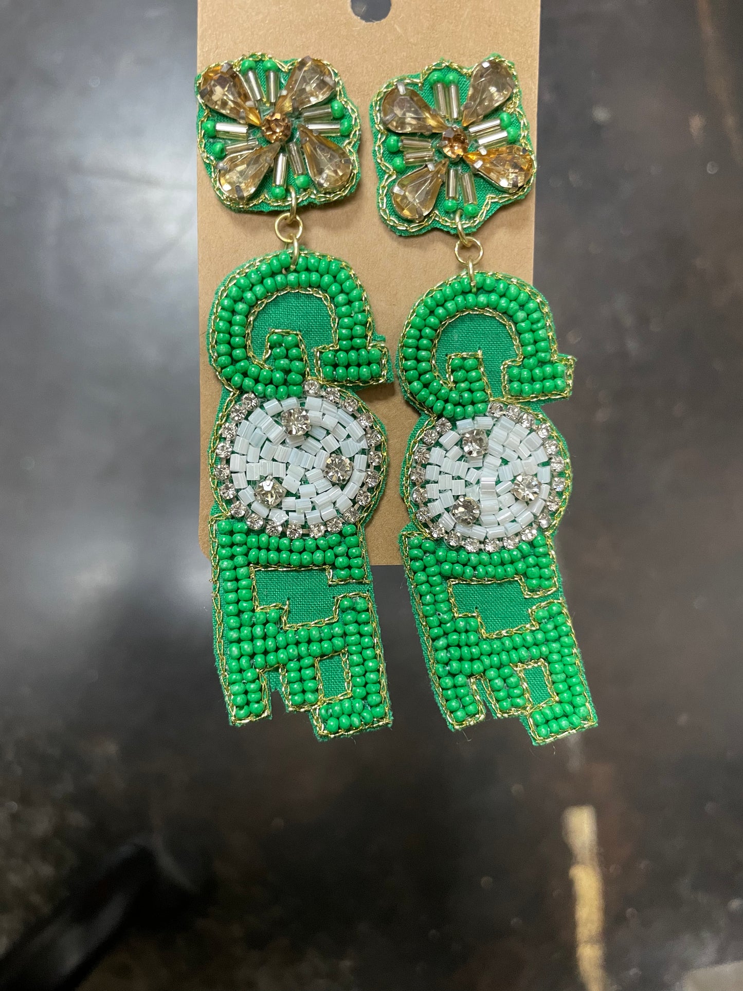 Beaded dangle earrings with jewel flower stud featuring "GOLF" in green and white beading.