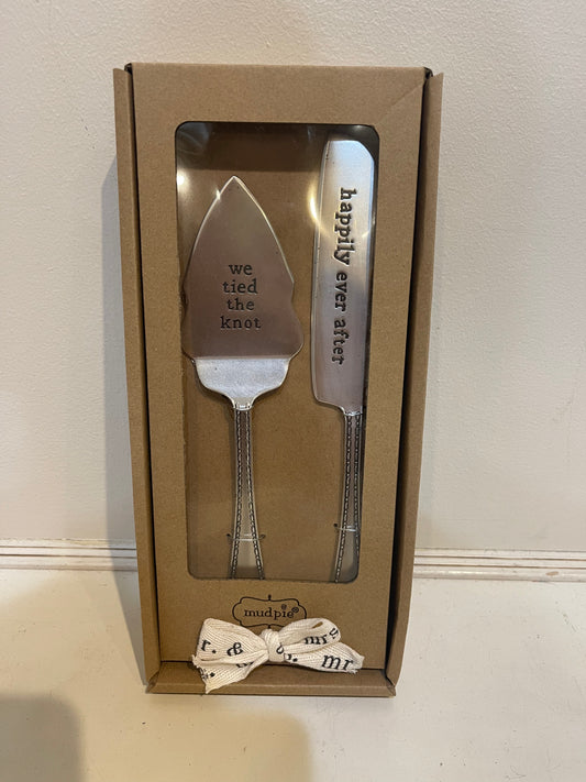 Silver color engraved wedding cake server set with the cake server displaying “We tied the knot” and the knife displaying “Happily Ever After”.