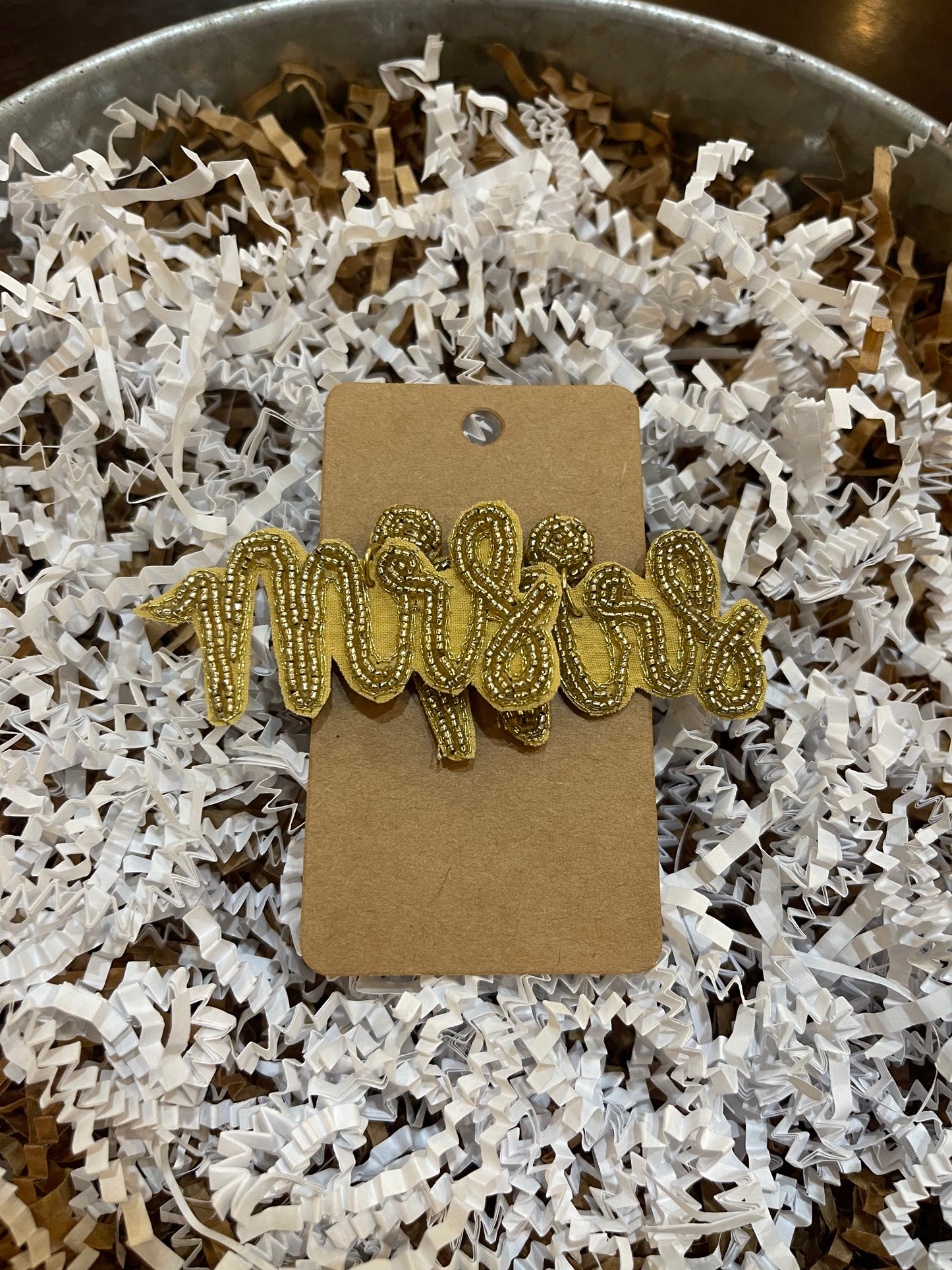 Gold beaded "Mrs" earrings.