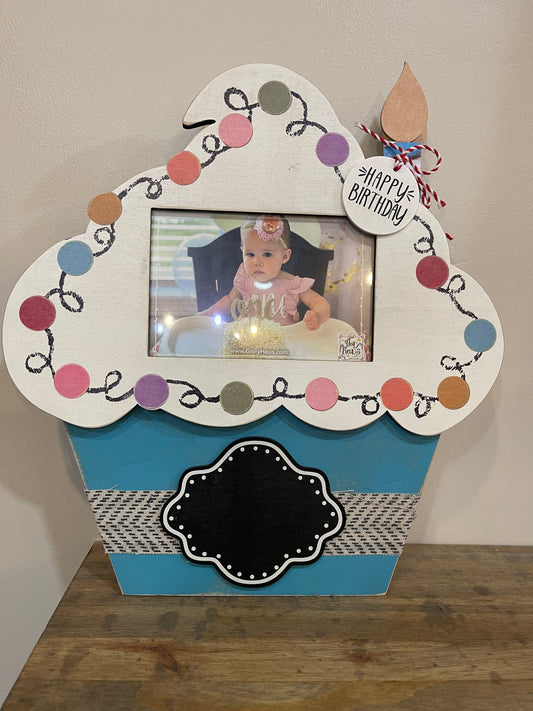 Wooden picture frame shaped like a cupcake.