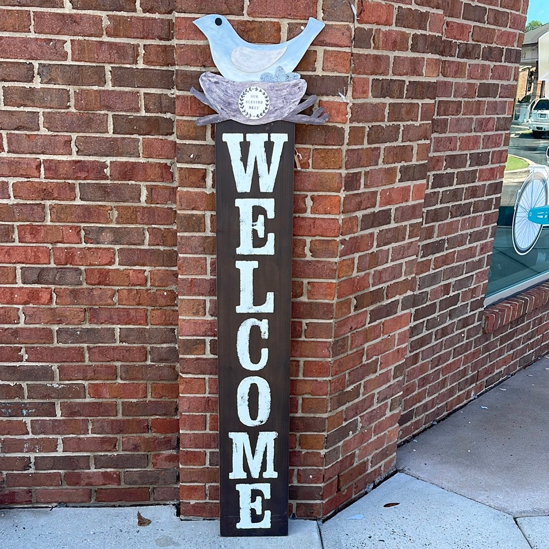 Brown Wooden Welcome Sign with bird in nest.