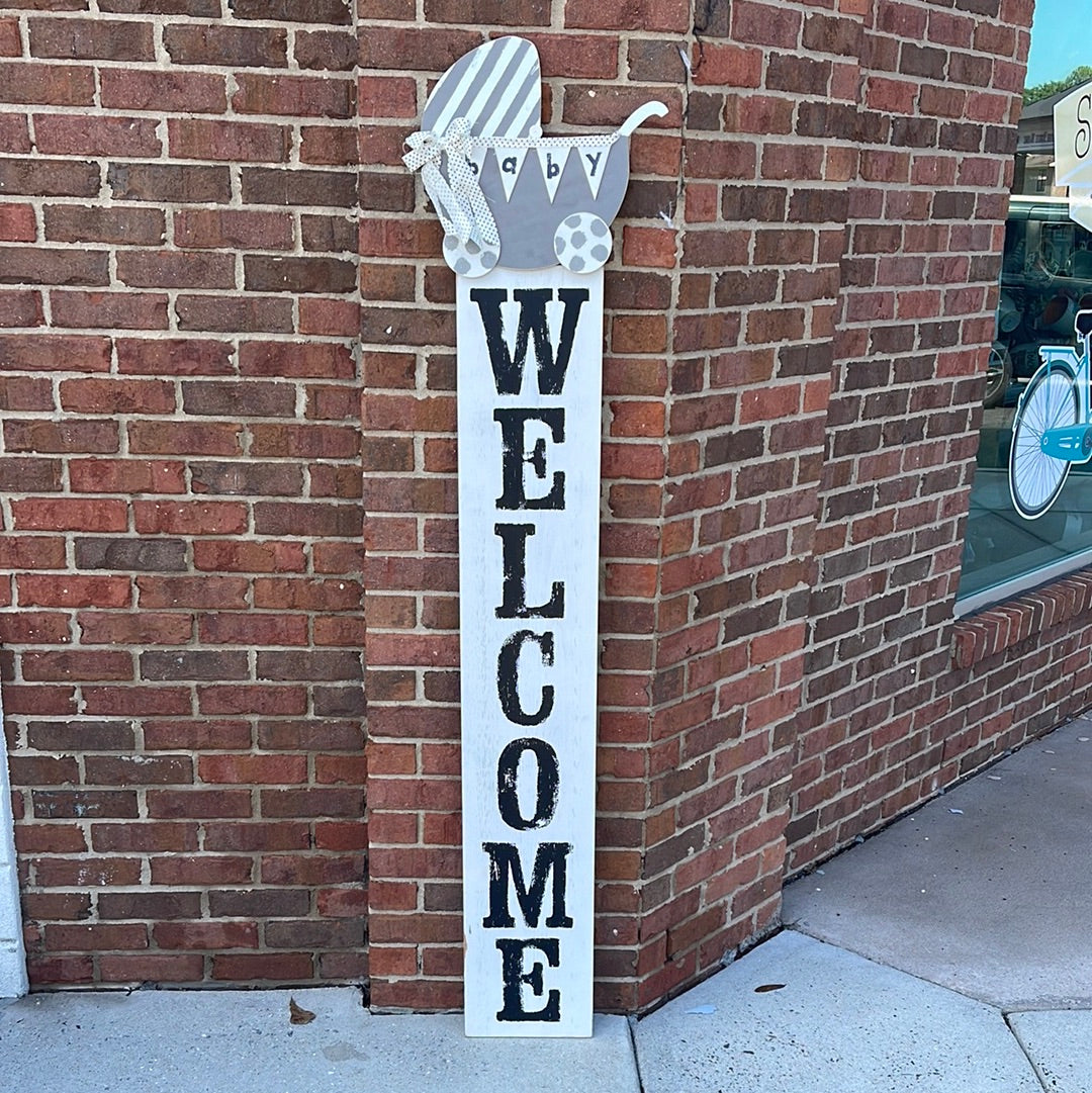 White Wooden Welcome Sign with baby carraige.