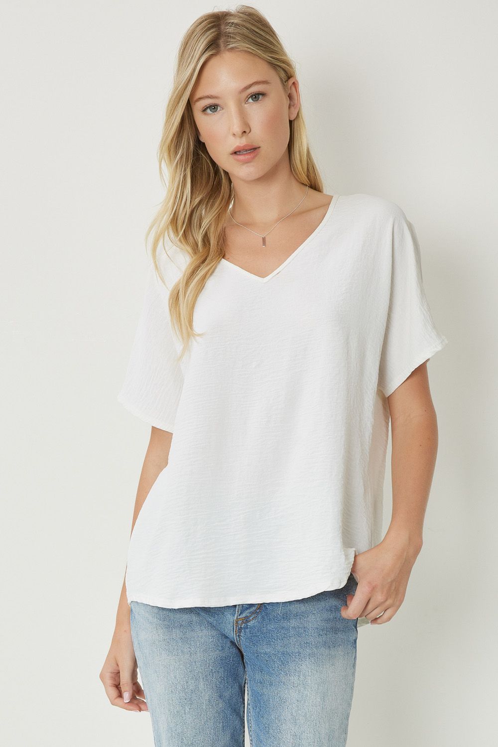 Women's white basic v-neck shirt.