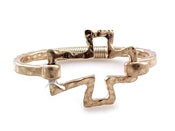 Burnt gold cross bracelet with hinge.
