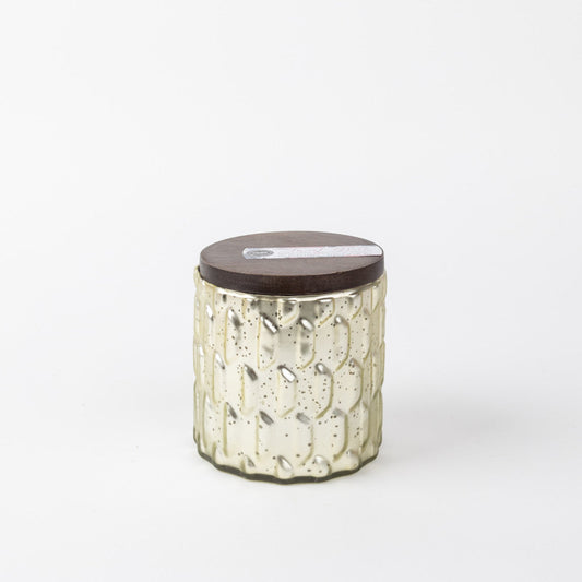 Candle in a gray, textured mercury glass jar.