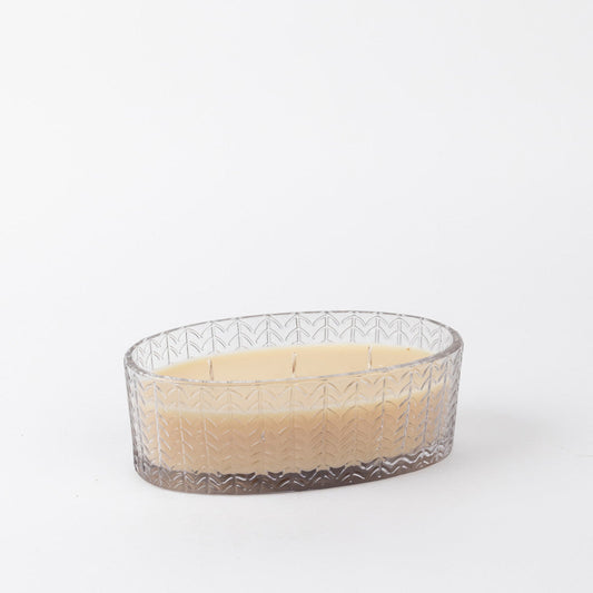 3-wick candle in a glass oval-shaped jar.