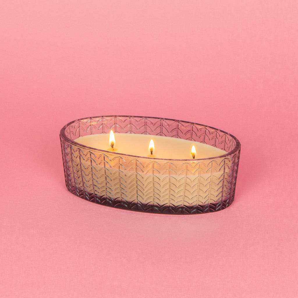 3-wick candle in a glass oval-shaped jar.
