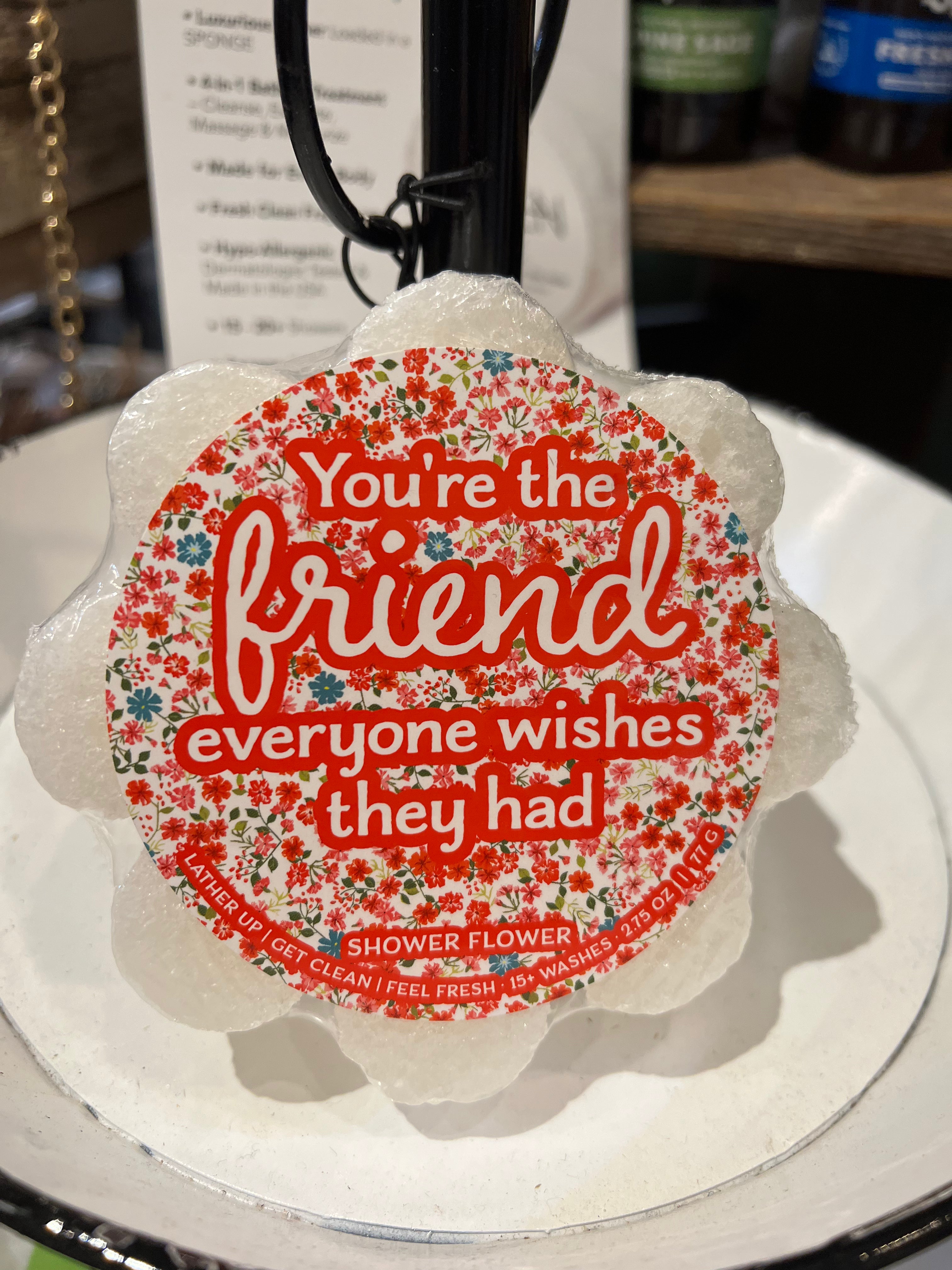 Caren "You're the friend everyone wishes they had" soap sponge shaped like a white flower.