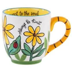 White handmade mug with yellow handle and flowers featuring "Always be kind".