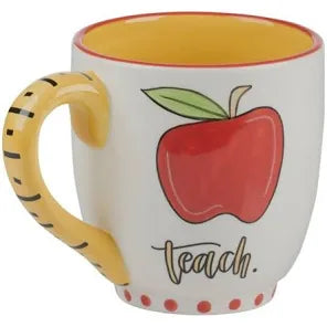 White handmade mug with yellow handle featuring an apple with "Teach".