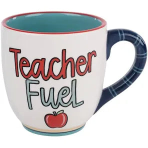 White handmade mug with blue handle featuring "Teacher fuel" with an apple.