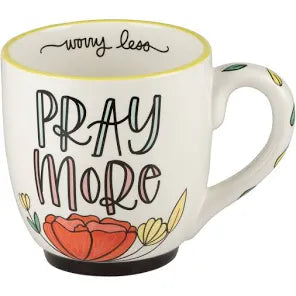 White handmade mug featuring "Pray more, worry less" with flowers.