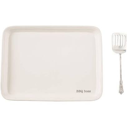 White platter that says "BBQ boss" with spatula.