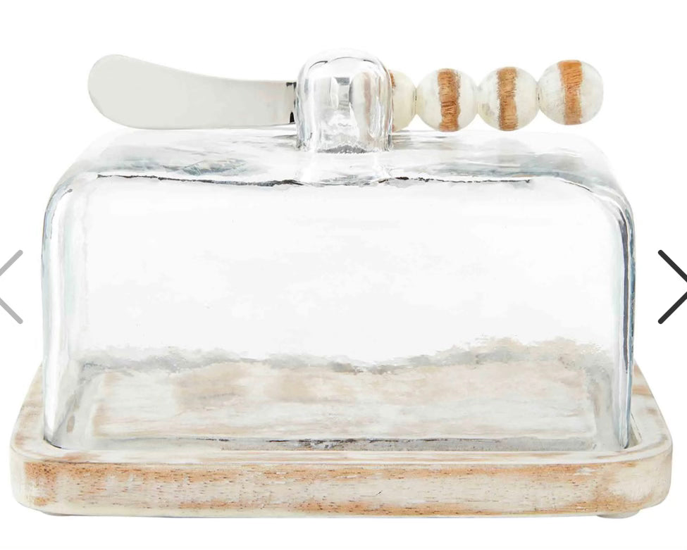 Glass butter dish with white-washed wooden base and white-washed beaded spreader.