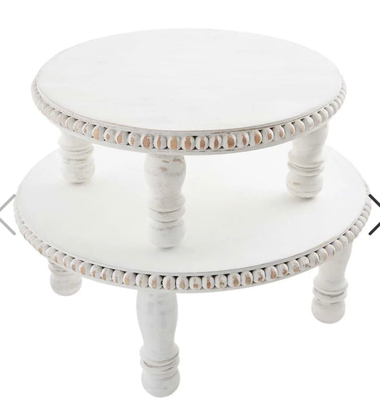 White wooden pedestals with a beaded edge.