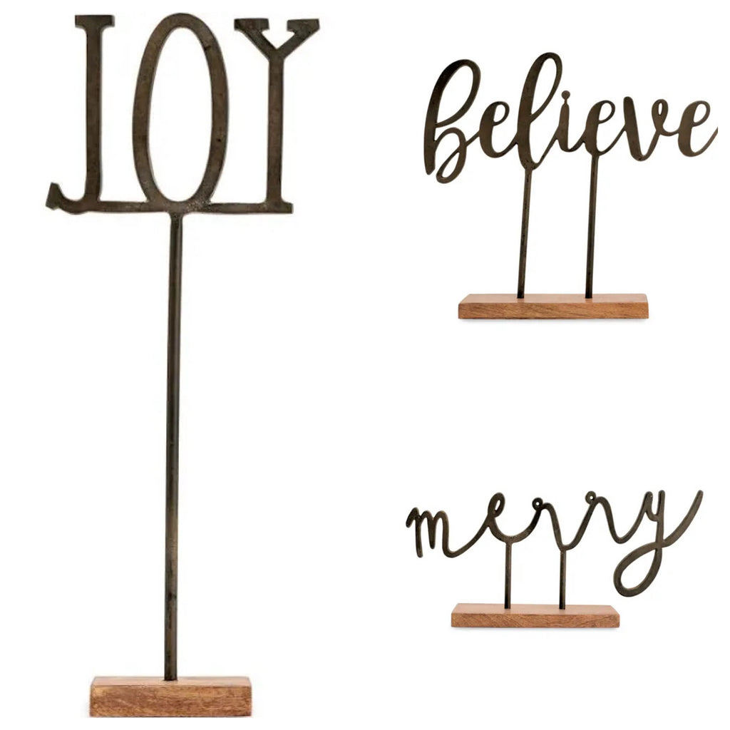 Assorted cast iron word art with wooden base featuring "Joy", "Believe", & "Merry".