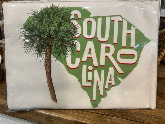 White flour sack hand towel with state of SC outline, palm tree, and "South Carolina".