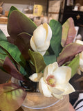 Artificial magnolia flowers and leaves.