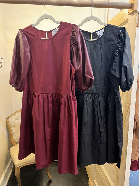 Assorted dresses with leather puff sleeves.