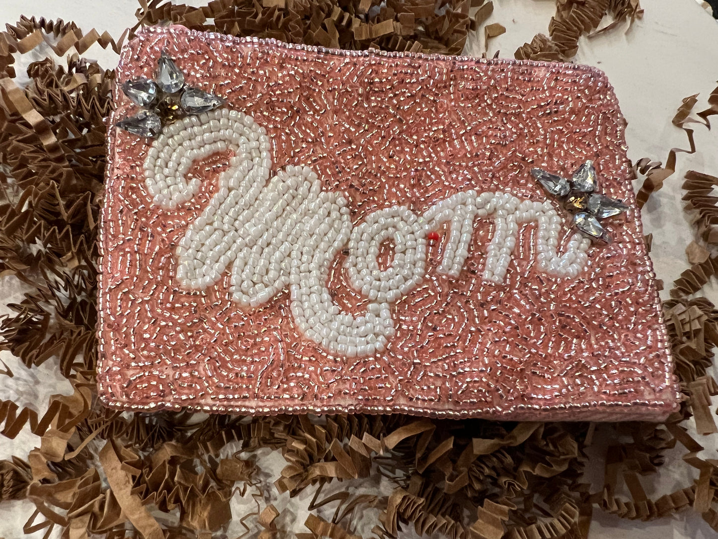 Pink square beaded coin bag with "Mom" in white beading with jewel accents.