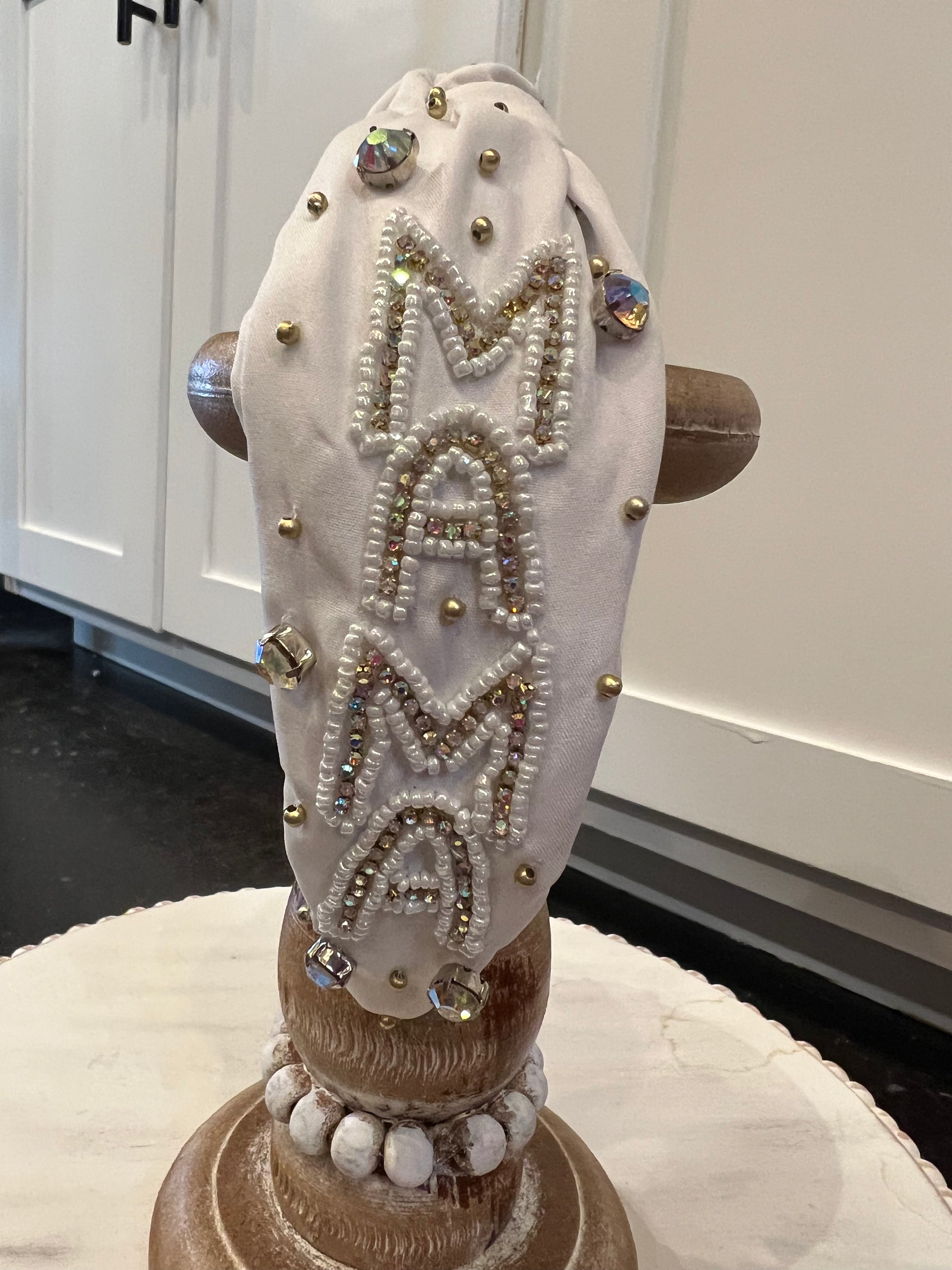 White beaded rhinestone headband featuring "MAMA".