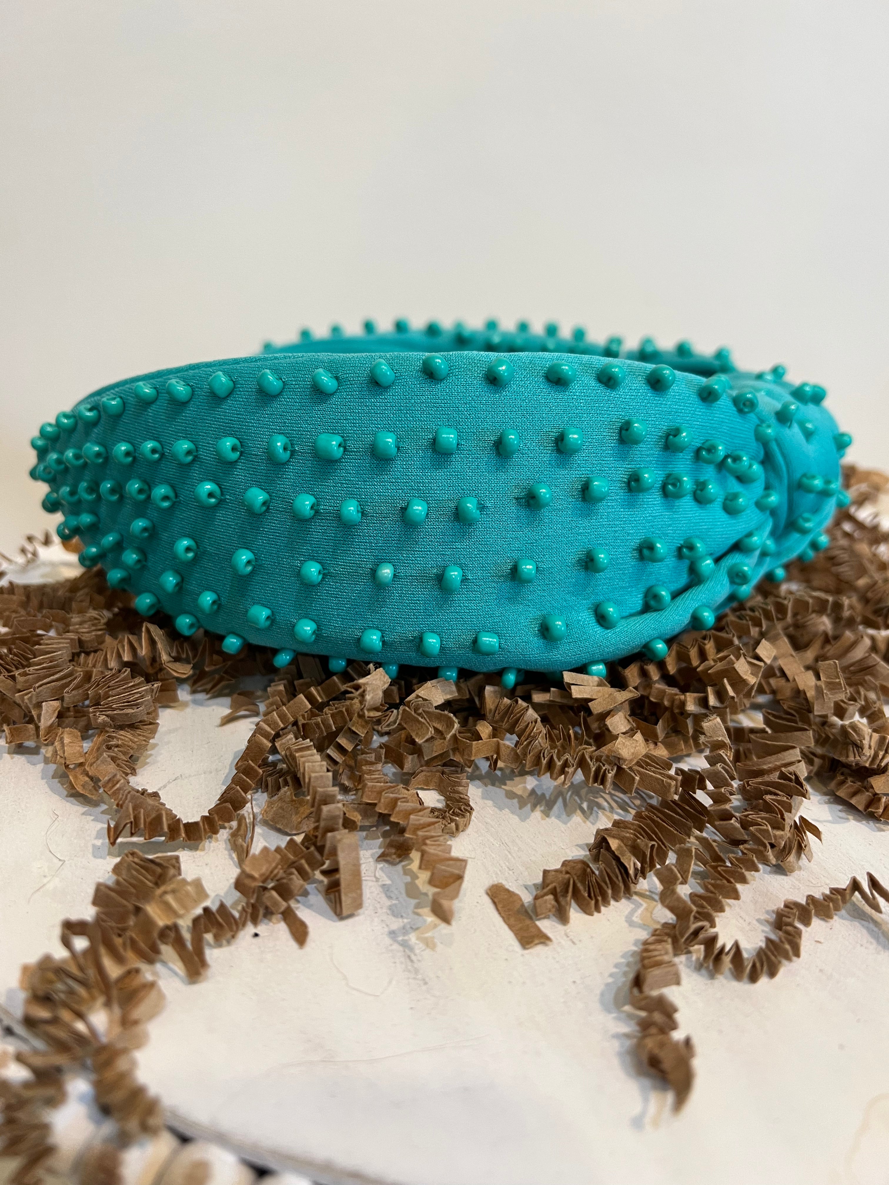 Green top knot headband with green beads.