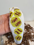 White topknot headband with neon yellow beaded softballs.
