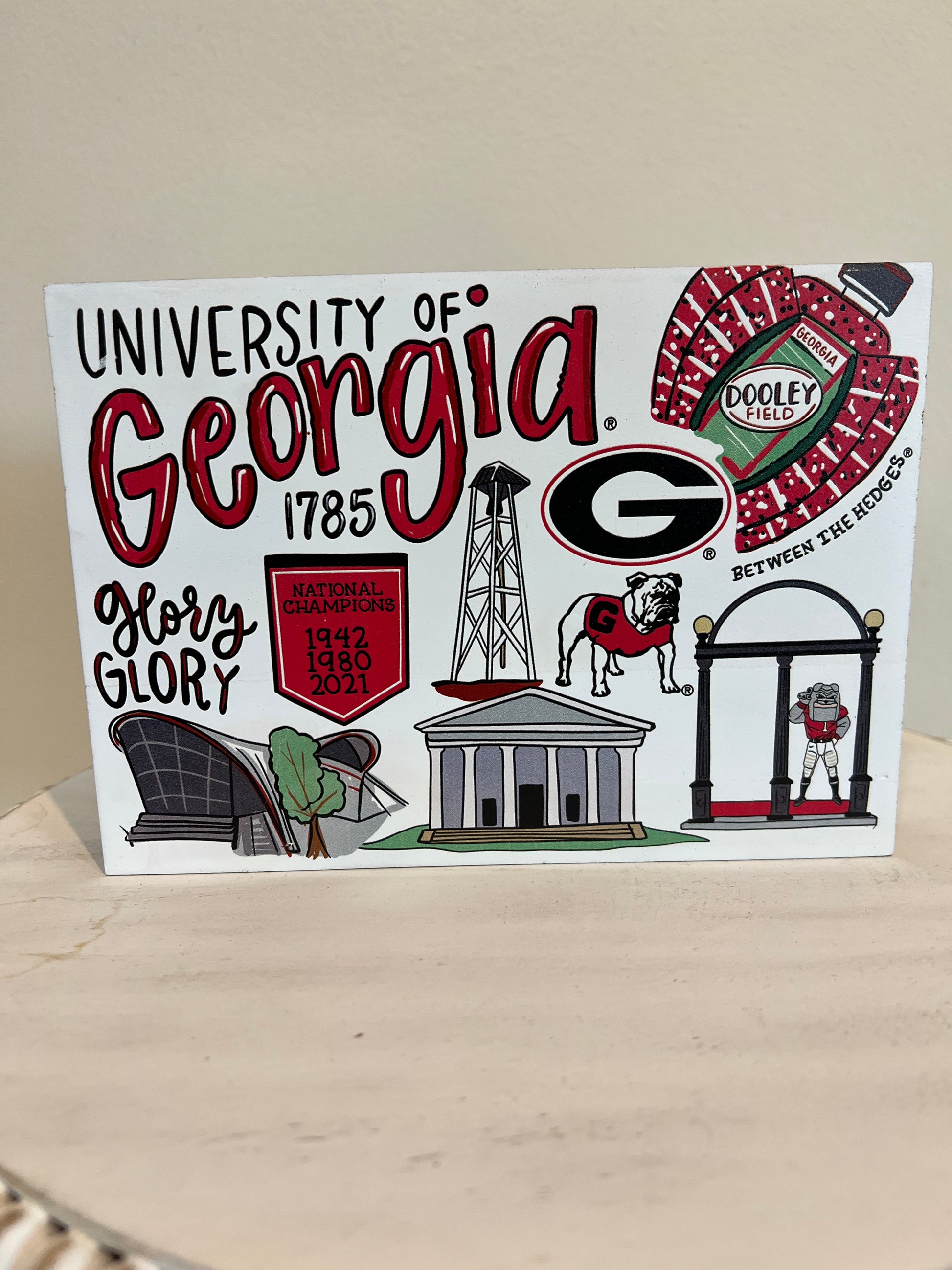 University of Georgia Collegiate Wooden Sign with depictions of campus. "1785; Glory Glory; National Champions 1942, 1980 2021; Between the Hedges".