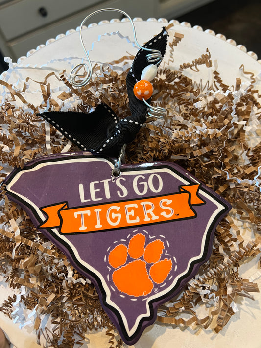 "Let's go Tigers" purple Clemson Christmas ornament shaped like South Carolina featuring an orange Clemson Tigers paw.