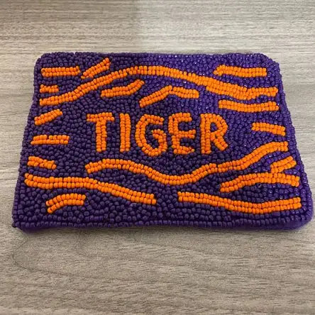 Purple and orange tiger striped beaded coin purse featuring "TIGER" in orange beading.