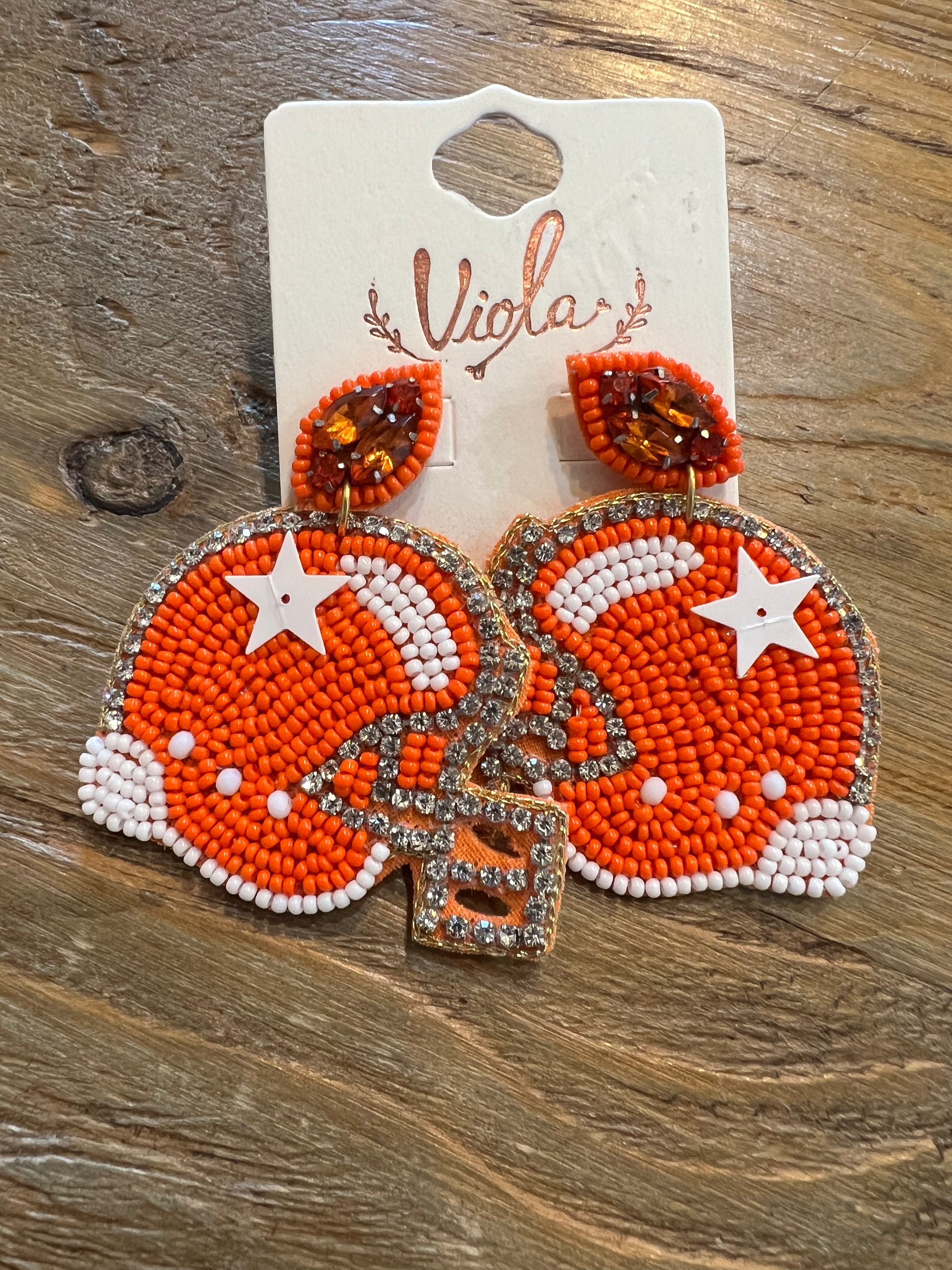 Orange and white beaded sports helmet earrings.