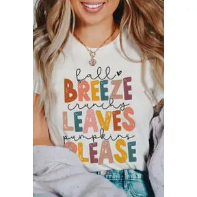 Model featuring a white t-shirt that displays "Fall Breeze, crunchy leaves, pumpkins please" in pink, burnt orange, yellow, blue, tan, and purple lettering.