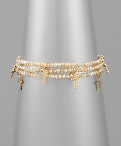 Beaded champagne colored cross bracelet with cross charms.