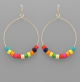 Multicolor wooden beads on dangling hoop earring.